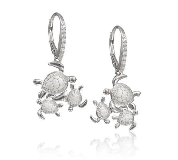 The picture shows a pair of 925 sterling silver three sea turtle earrings with topaz.