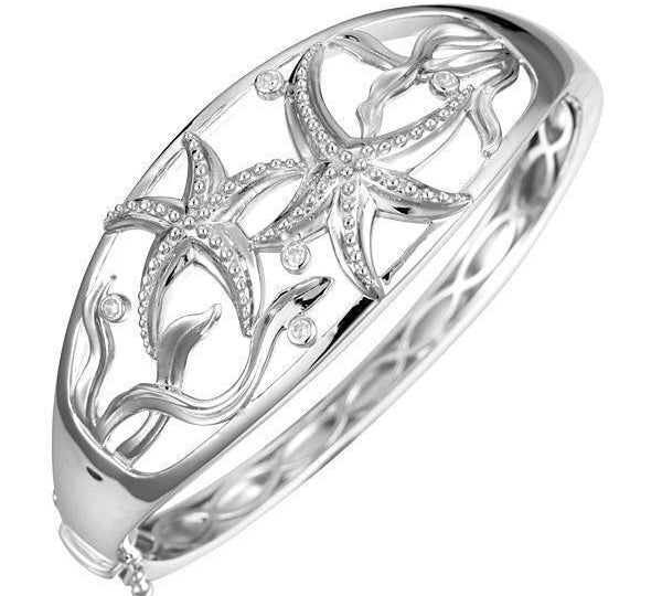 The picture shows a 925 sterling silver two starfish bangle with seaweed and topaz.