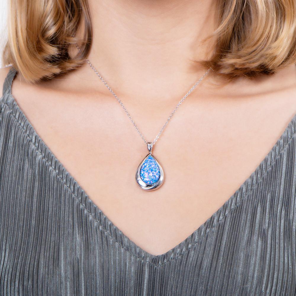 The picture shows a model wearing a 925 sterling silver opalite teardrop pendant.