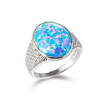 This photo shows a 925 sterling silver cocktail ring paired with an oval opalite gemstone and cubic zirconia