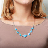 The picture shows a model wearing a 925 sterling silver opalite cushion cut necklace.