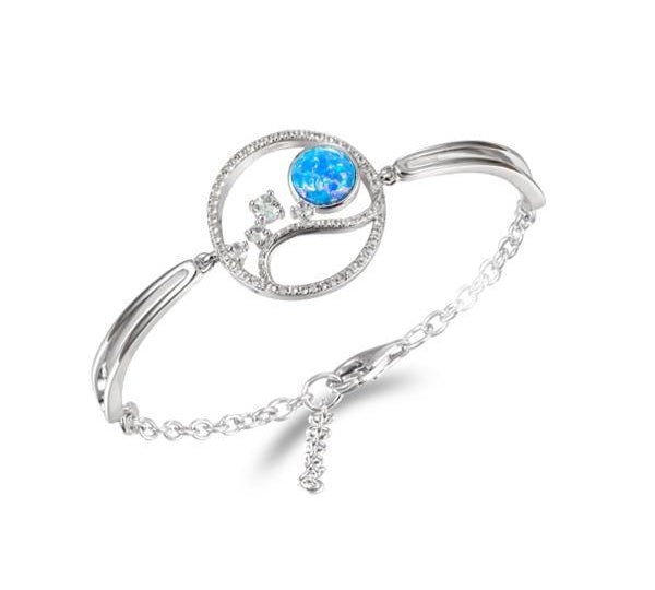 In this photo there is a 925 sterling silver wave and sun bracelet with blue opalite, aquamarine and topaz gemstones.