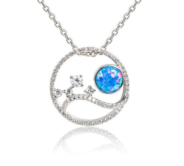 In this photo there is a sterling silver circle pendant with blue opalite, aquamarine and cubic zirconia.