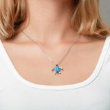 The picture shows a model wearing a 925 sterling silver opalite sea turtle pendant.