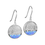 In this photo there is a pair of sterling silver lighthouse medallion hook earrings with blue opalite and topaz gemstones.