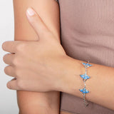 The picture shows a model wearing a 925 sterling silver opalite three manta ray bracelet.