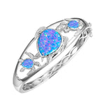 The picture shows a 925 sterling silver family of three sea turtles bangle with opalite.