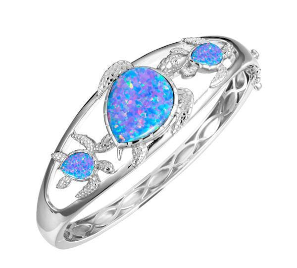 The picture shows a 925 sterling silver family of three sea turtles bangle with opalite.