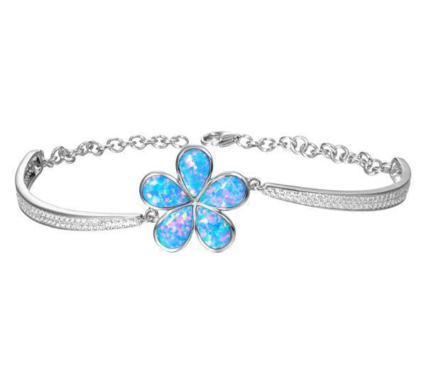 In this photo there is a sterling silver plumeria bracelet with blue opalite gemstones and cubic zirconia.