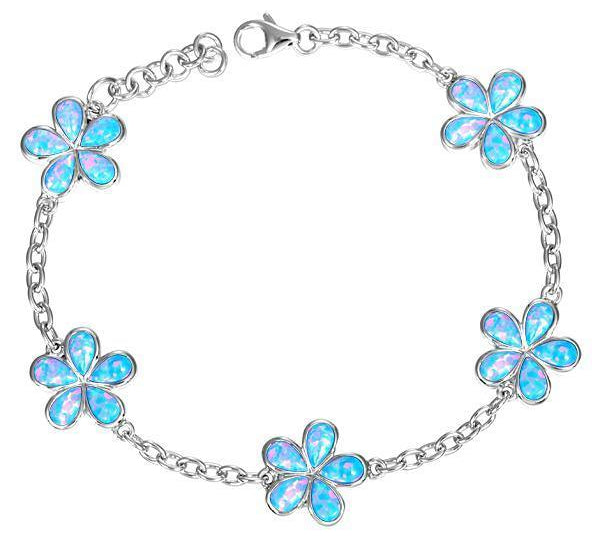 In this photo there is a sterling silver charm bracelet with five plumeria flowers and blue opalite gemstones.