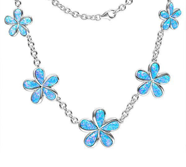 In this photo there is a sterling silver charm necklace with five plumeria flowers and blue opalite gemstones.