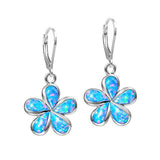 In this photo there is a pair of sterling silver plumeria earrings with blue opalite gemstones.