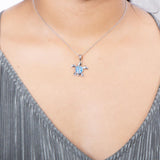The picture shows a model wearing a 925 sterling silver opalite sea turtle pendant.