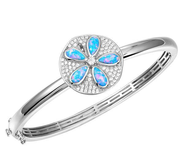 The picture shows a 925 sterling silver sand dollar bangle with blue opalite and topaz.