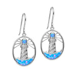 In this photo there is a pair of sterling silver shining lighthouse hook earrings with blue opalite and topaz gemstones.