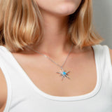 The picture shows a model wearing a 925 sterling silver opalite shooting star pendant and topaz.