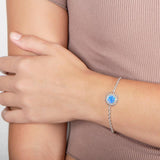 In this photo there is a model wearing a 925 sterling silver sunflower bracelet with one blue opalite gemstone