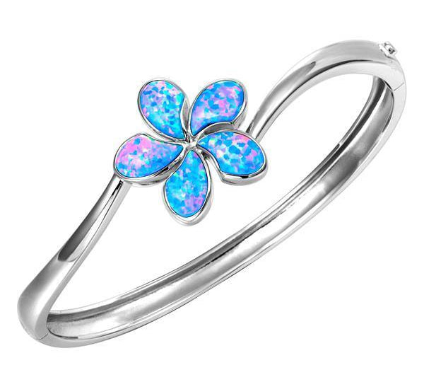 In this photo there is a 925 sterling silver plumeria bangle with blue opalite gemstones.