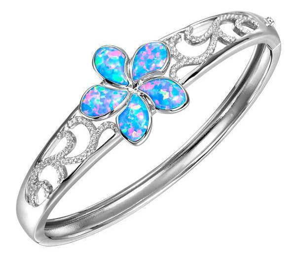 In this photo there is a 925 sterling silver plumeria bangle with blue opalite gemstones and cubic zirconia.