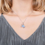 The picture shows a model wearing a 925 sterling silver opalite sea turtle pendant.