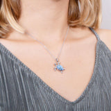 The picture shows a model wearing a 925 sterling silver opalite sea turtle pendant.