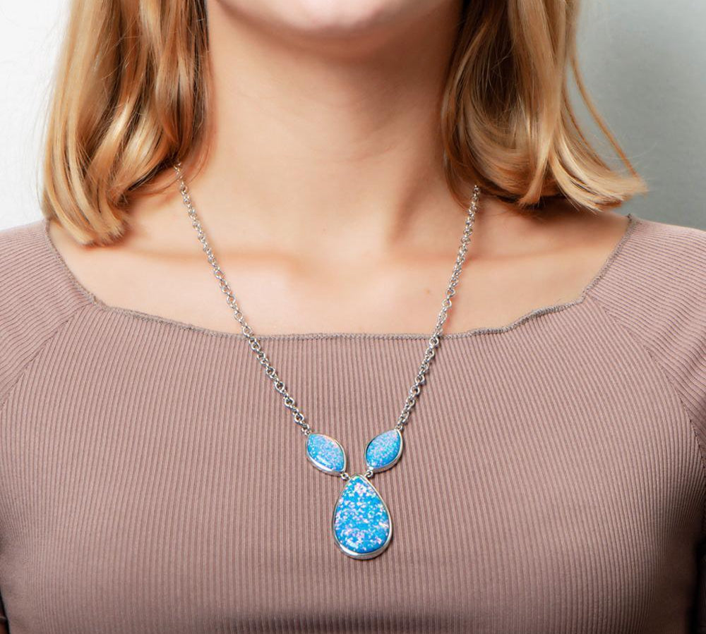 The picture shows a model wearing a 925 sterling silver opalite three drop necklace.