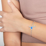 The picture shows a model wearing a 925 sterling silver opalite sea turtle bracelet.