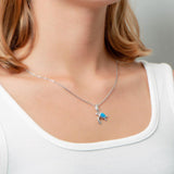 The picture shows a model wearing a 925 sterling silver opalite sea turtle pendant.