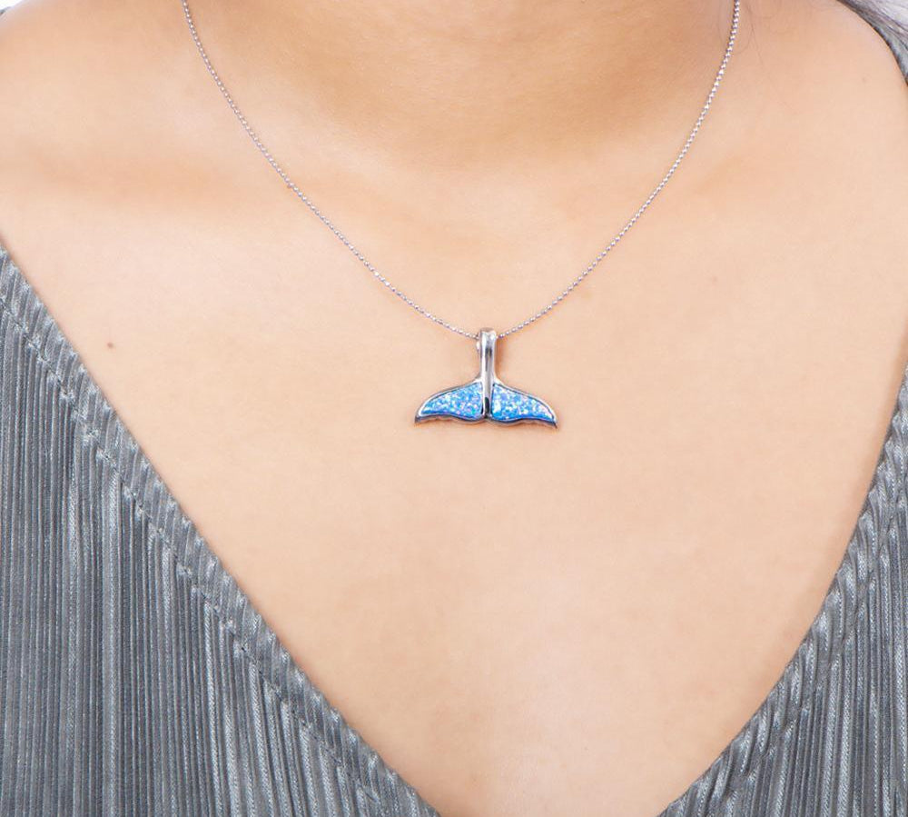 The picture shows a model wearing a 925 sterling silver opalite whale tail pendant.
