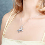 The picture shows a model wearing a 925 sterling silver sea turtle pendant.