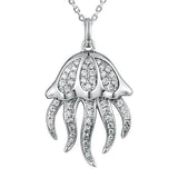 The picture shows a 925 sterling silver, white gold plated, pavé barrel jellyfish pendant with topaz.