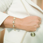 The picture shows a model wearing a 925 sterling silver yellow gold plated blue crab bracelet with topaz.