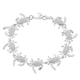 The picture shows a 925 sterling silver white gold plated blue crab bracelet with topaz.
