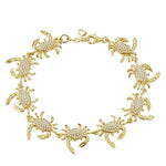 The picture shows a 925 sterling silver yellow gold plated blue crab bracelet with topaz.