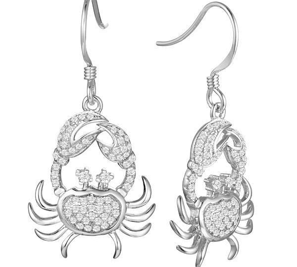 The photo shows a pair of solid white gold pavé crab hook earrings.