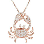 The picture shows a 925 sterling silver, rose gold plated, pavé crab pendant with topaz.