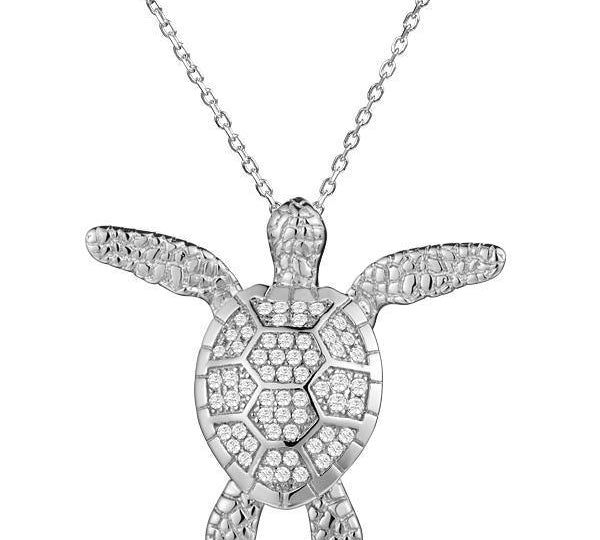 In this photo there is a white gold sea turtle pendant with cubic zirconia.