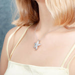 The picture shows a model wearing a 925 sterling silver, white gold vermeil, happy starfish pendant with topaz.