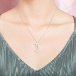 The picture shows a model wearing a 925 sterling silver, white gold vermeil, hanging double starfish pendant with topaz.
