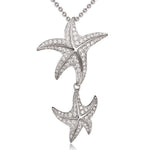 The picture shows a 925 sterling silver, white gold vermeil, hanging double starfish pendant with topaz.