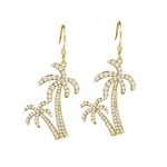 The picture shows a pair of 14K yellow gold pavé palm trees hook earrings with diamonds.