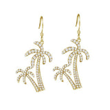 The picture shows a pair of 14K yellow gold pavé palm trees hook earrings with diamonds.