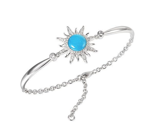 In this photo there is a 925 sterling silver sun bracelet with blue larimar, topaz, and aquamarine gemstones.