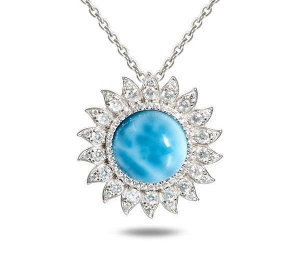 In this photo there is a sterling silver sunflower pendant with topaz and one blue larimar gemstone.