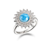 In this photo there is a 925 sterling silver sunflower ring with one blue larimar gemstone and topaz.