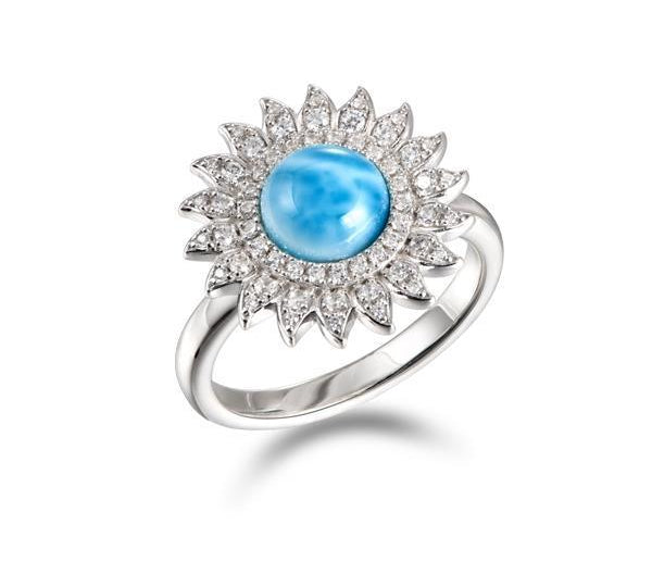 In this photo there is a 925 sterling silver sunflower ring with one blue larimar gemstone and topaz.