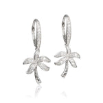 In this photo there is a pair of sterling silver palm tree earrings with topaz gemstones.