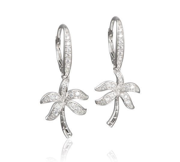 In this photo there is a pair of sterling silver palm tree earrings with topaz gemstones.