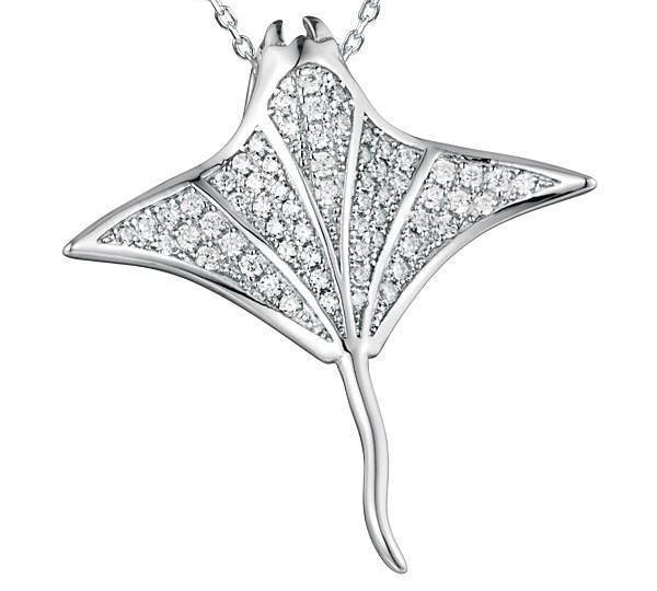 The picture shows a 925 sterling silver, white gold vermeil, pavé manta ray pendant with topaz.