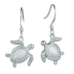 The picture shows a pair of 925 sterling silver white gold-vermeil sea turtle hook earrings with topaz.